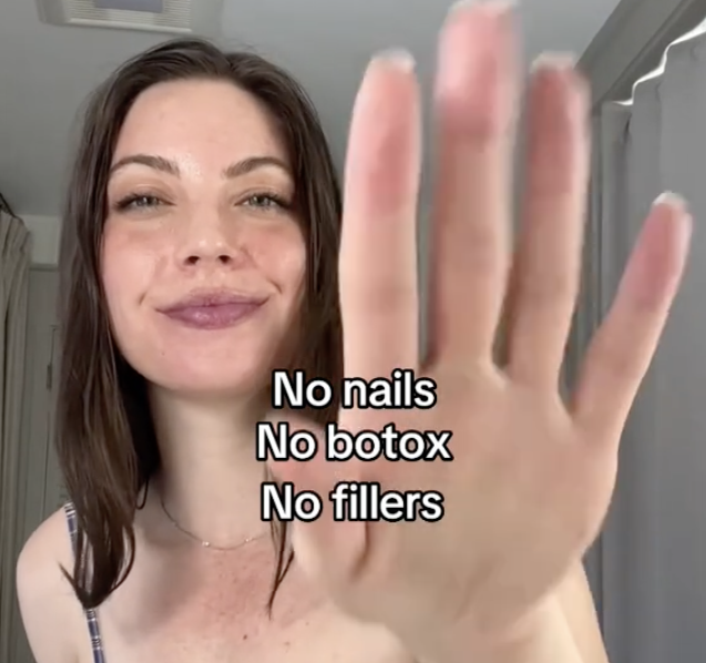 woman holding up her hand with palm exposed